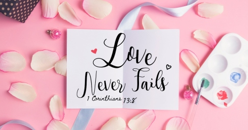 Love never fails on pastel background.